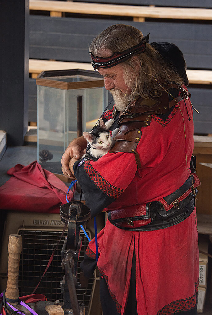 Lance Bert holds some adoptable cats before starting a blacksmith demonstration at the Pennsylvania Renaissance Faire on Sunday September 13, 2025. Lance Bert is the owner of LA Forge in Manheim PA where they make weapons and help adoptable cats find homes.