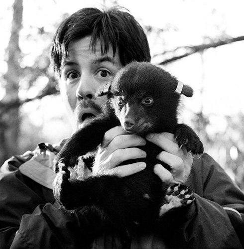 John Whitehead holding a Bear Cub found in Pike County.